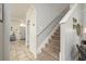 Inviting foyer with tile flooring, staircase, and an entryway view, creating a welcoming atmosphere at 1810 Winsloe Dr, Trinity, FL 34655