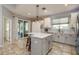 Bright kitchen with a center island, pendant lighting, modern appliances, and a tile backsplash at 1810 Winsloe Dr, Trinity, FL 34655