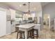 Kitchen boasts stainless steel appliances, a center island with barstool seating, pendant lights, and tiled floors at 1810 Winsloe Dr, Trinity, FL 34655