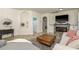 Cozy living room with tiled floors, a fireplace, and a comfortable seating area, great for relaxing at 1810 Winsloe Dr, Trinity, FL 34655