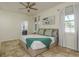 Cozy main bedroom features soft decor, ceiling fan, tiled floor and an ensuite bathroom at 1810 Winsloe Dr, Trinity, FL 34655