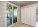Patio access from kitchen, showing closet and neutral paint at 1810 Winsloe Dr, Trinity, FL 34655