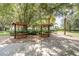 Outdoor picnic area with covered tables, perfect for gatherings and enjoying meals in a beautiful outdoor setting at 1810 Winsloe Dr, Trinity, FL 34655