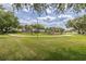 Community playground featuring modern play structures, green grass and shaded seating areas for neighborhood gatherings and Gathering fun at 1810 Winsloe Dr, Trinity, FL 34655
