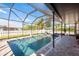 Inviting screened pool area featuring clear blue water, lounge chairs, and a relaxing atmosphere at 1810 Winsloe Dr, Trinity, FL 34655