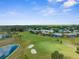 Aerial view showcasing the golf course, community layout, and surrounding landscape at 18209 Breland Dr, Hudson, FL 34667