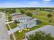 Bright aerial view showcasing a home with a screened pool and golf course, set in a charming neighborhood at 18209 Breland Dr, Hudson, FL 34667