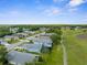 Neighborhood aerial showcasing well-maintained homes, lush greenery, and a tranquil golf course setting at 18209 Breland Dr, Hudson, FL 34667