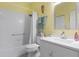 Well-lit bathroom featuring a shower over tub, a sink with lots of counter space, and good lighting at 18209 Breland Dr, Hudson, FL 34667