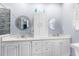 Bright bathroom with double vanity, modern fixtures, and glass enclosed shower at 18209 Breland Dr, Hudson, FL 34667