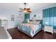 Comfortable bedroom featuring wood flooring, ceiling fan, and tasteful decorations at 18209 Breland Dr, Hudson, FL 34667