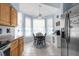Kitchen nook with a breakfast table surrounded by natural light, tile floors, and stainless steel appliances at 18209 Breland Dr, Hudson, FL 34667