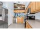 Bright kitchen featuring light wood cabinets, stainless steel appliances, tile flooring, and a decorative wood accent wall at 18209 Breland Dr, Hudson, FL 34667