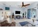 Open living room features tile flooring, ceiling fan, and sliding door access to lanai at 18209 Breland Dr, Hudson, FL 34667