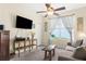 Cozy living room with a lake view, ceiling fan, comfortable seating, and lots of natural light at 18209 Breland Dr, Hudson, FL 34667