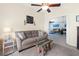 Inviting living room with a comfortable sofa, area rug, and an open view to another room at 18209 Breland Dr, Hudson, FL 34667