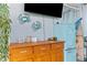 Outdoor patio area with decorative crab wall hangings, refrigerator, and wood storage cabinet at 18209 Breland Dr, Hudson, FL 34667
