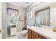 Bright bathroom featuring a wood vanity, framed mirror, and a window with natural lighting at 18532 Myrtlewood Dr, Hudson, FL 34667