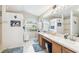 Bright bathroom featuring dual sinks, a large mirror, and ample counter space at 18532 Myrtlewood Dr, Hudson, FL 34667