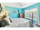 Comfortable bedroom with a large window and blue walls at 18532 Myrtlewood Dr, Hudson, FL 34667