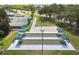 Aerial view of community bocce ball courts with shade canopies and seating at 18532 Myrtlewood Dr, Hudson, FL 34667