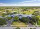Gorgeous aerial view of the community clubhouse, golf course, and surrounding neighborhood at 18532 Myrtlewood Dr, Hudson, FL 34667