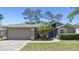 Well-maintained single-story home featuring an attached two-car garage and a beautifully landscaped front yard at 18532 Myrtlewood Dr, Hudson, FL 34667
