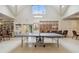 Game room features a ping pong table and organized storage for activities and crafts at 18532 Myrtlewood Dr, Hudson, FL 34667