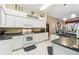 Bright kitchen with white cabinetry, granite countertops, and stainless steel appliances at 18532 Myrtlewood Dr, Hudson, FL 34667