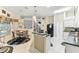 Open concept kitchen with an island, white cabinets and marble floors at 18532 Myrtlewood Dr, Hudson, FL 34667
