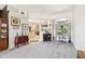 Open-concept living area with neutral walls, plush carpeting and decorative shelving at 18532 Myrtlewood Dr, Hudson, FL 34667