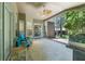 Enjoyable screened patio with ceiling fan, furniture, and outdoor access at 18532 Myrtlewood Dr, Hudson, FL 34667
