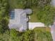 An aerial view of a home featuring a private pool and a long driveway at 18620 Gracie Lee St, Spring Hill, FL 34610