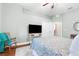 Bedroom featuring hardwood floors, a rocking chair, and a ceiling fan at 18620 Gracie Lee St, Spring Hill, FL 34610