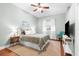 Cozy bedroom with hardwood floors, ceiling fan, and neutral wall color at 18620 Gracie Lee St, Spring Hill, FL 34610