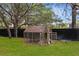 Backyard chicken coop with ample space for poultry, offering a touch of country living at 18620 Gracie Lee St, Spring Hill, FL 34610