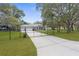 Charming single-story home with a gated entrance and lush green lawn, providing privacy and curb appeal at 18620 Gracie Lee St, Spring Hill, FL 34610
