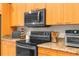 Well-equipped kitchen with granite countertops, stainless steel appliances, and ample cabinet space at 18620 Gracie Lee St, Spring Hill, FL 34610