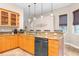 Bright kitchen with maple cabinets, granite countertops, and modern stainless steel appliances at 18620 Gracie Lee St, Spring Hill, FL 34610