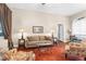Cozy living room with natural light, comfortable seating, and a warm color palette at 18620 Gracie Lee St, Spring Hill, FL 34610