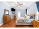 Well-appointed main bedroom with wood floors, TV, and an ensuite at 18620 Gracie Lee St, Spring Hill, FL 34610