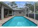 Screened-in pool with lovely patio area, perfect for backyard entertainment and leisure at 18620 Gracie Lee St, Spring Hill, FL 34610