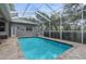Spacious screened-in pool area offering a serene and private backyard retreat at 18620 Gracie Lee St, Spring Hill, FL 34610