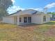 Rear exterior view of the home with a covered patio and well-maintained yard at 19855 Ellendale Dr, Land O Lakes, FL 34638