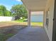 View of the backyard from the covered patio with green grass and mature trees at 19855 Ellendale Dr, Land O Lakes, FL 34638