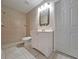 Bathroom with a tiled walk-in shower, white vanity and tiled floors at 19855 Ellendale Dr, Land O Lakes, FL 34638
