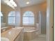 Bathroom with double sinks, tub, and glass shower at 19855 Ellendale Dr, Land O Lakes, FL 34638