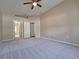 Spacious carpeted bedroom with a ceiling fan and an ensuite bathroom at 19855 Ellendale Dr, Land O Lakes, FL 34638