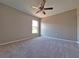Spacious bedroom with neutral carpet, ceiling fan, and a window letting in natural light at 19855 Ellendale Dr, Land O Lakes, FL 34638