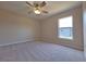 This carpeted bedroom includes a ceiling fan and natural light at 19855 Ellendale Dr, Land O Lakes, FL 34638